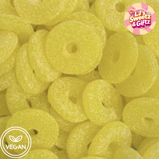 Close-up of yellow pineapple rings with 'LJ's Sweetz & Giftz' branding and a vegan label.